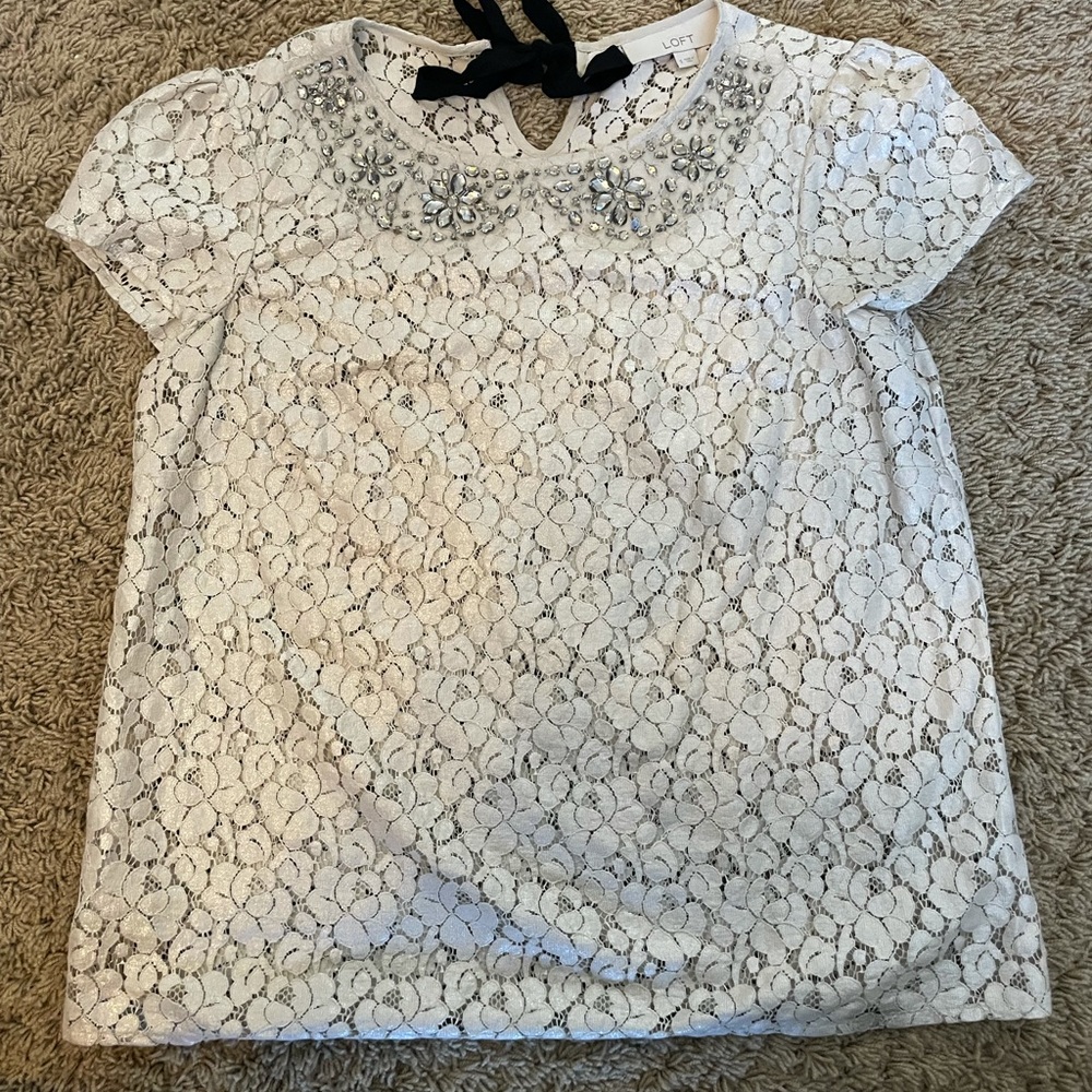 Lace top with gem embellishments around collar